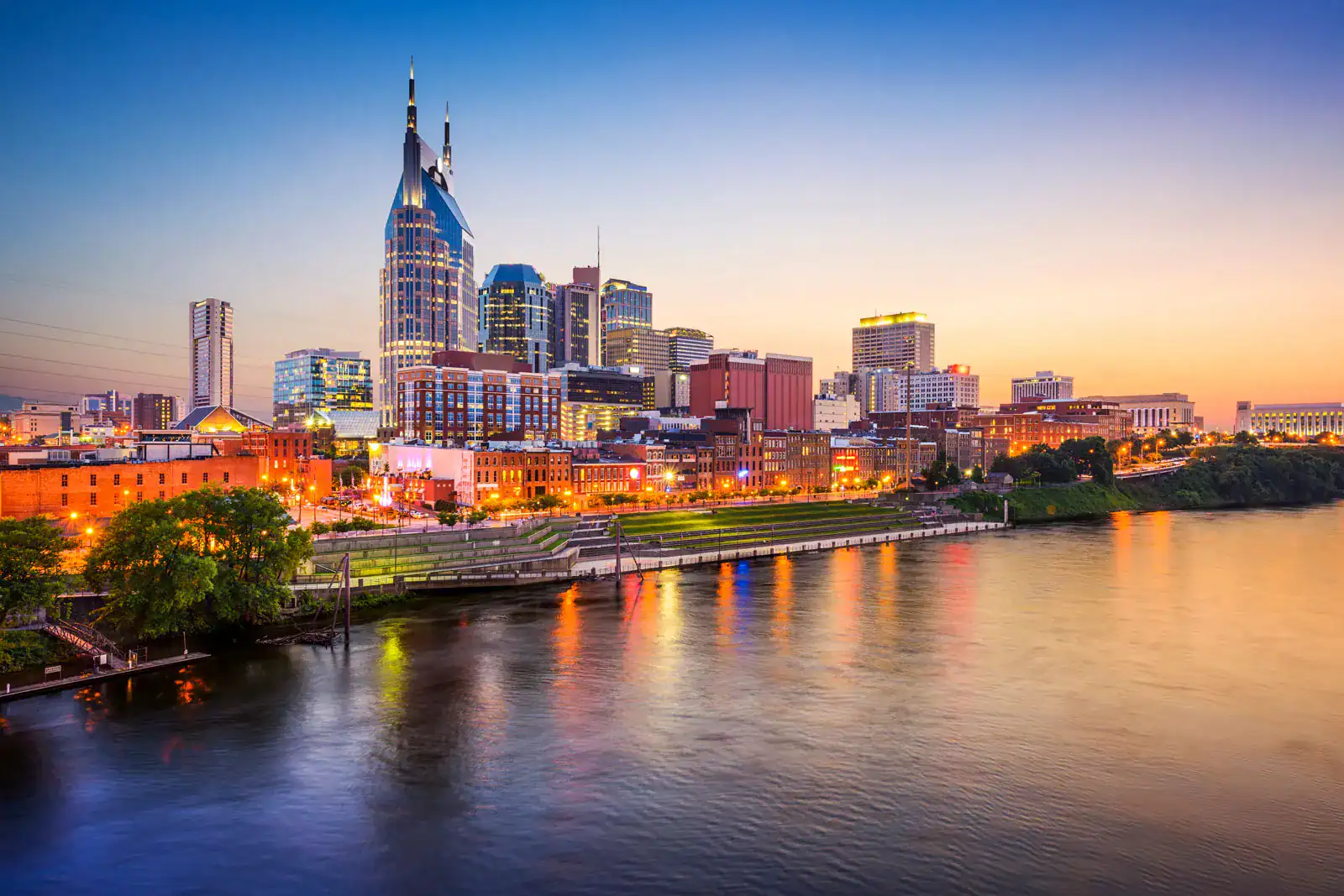 Nashville city skyline at sunset by river