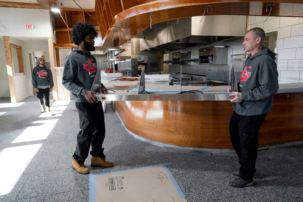 a pert of the commercial kitchen, is being moved out of the property by two movers of fox moving and storage