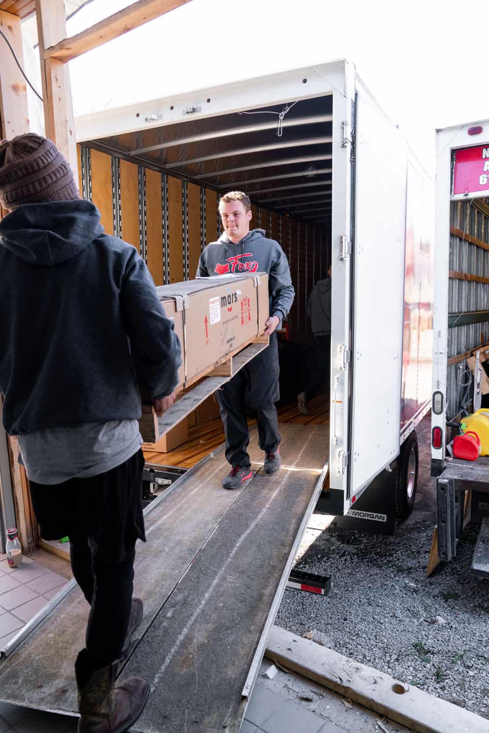 fox moving and storage movers are loading large create onto their moving truck