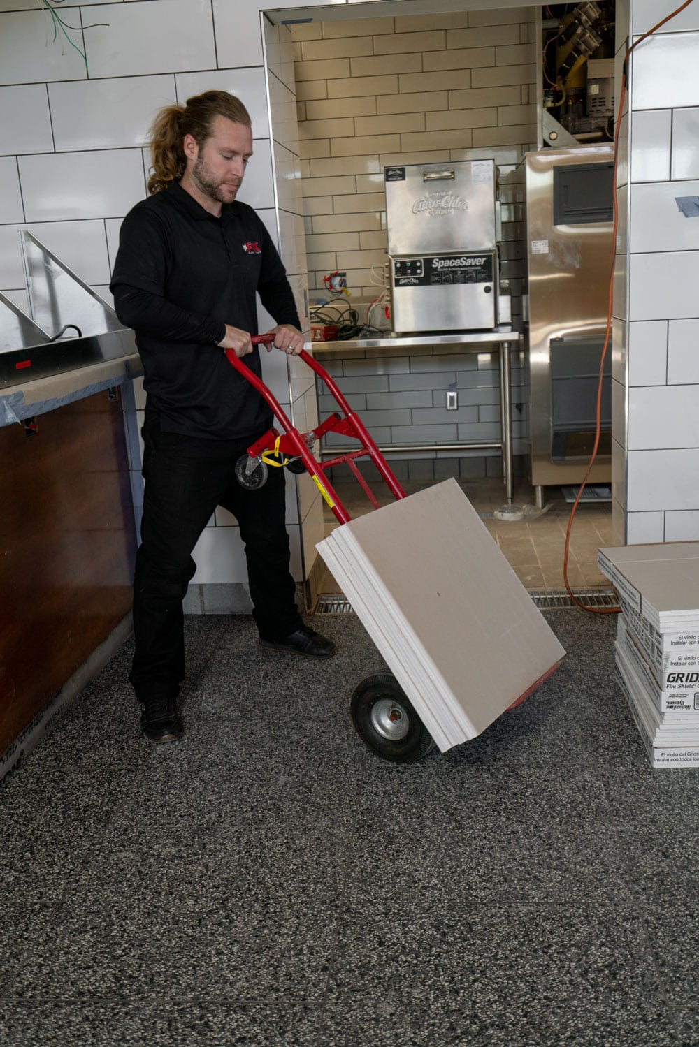 mover of fox moving and storage, moving tiles of some sort from the kitchen with a dolley